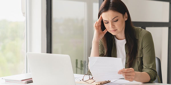 Stressed business woman viewing potential fraud